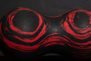 Black and red abstract design on a textured surface Roller-Peanut-Foam-COREFX Red and black marbled object on a white background